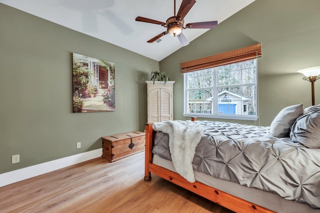 bedroom featuring ceiling fan, light hardwood / wood-style floors, and vaulted ceiling