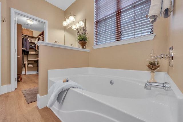 bathroom featuring a bath and hardwood / wood-style floors