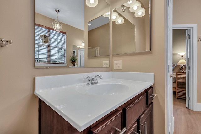 bathroom with hardwood / wood-style floors and vanity