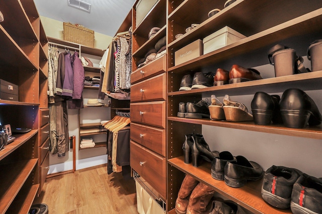 walk in closet featuring light hardwood / wood-style flooring