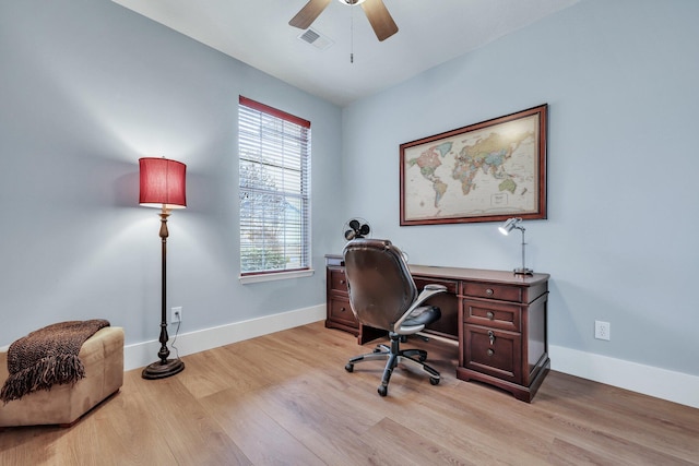 home office featuring light wood-type flooring and ceiling fan