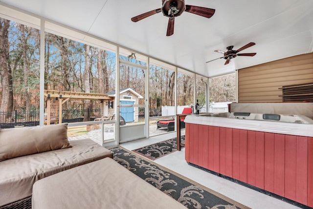 sunroom / solarium with ceiling fan and a hot tub