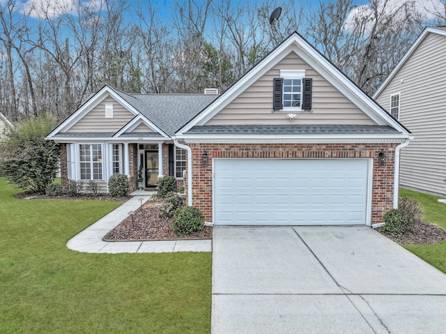 view of front of property with a garage and a front lawn