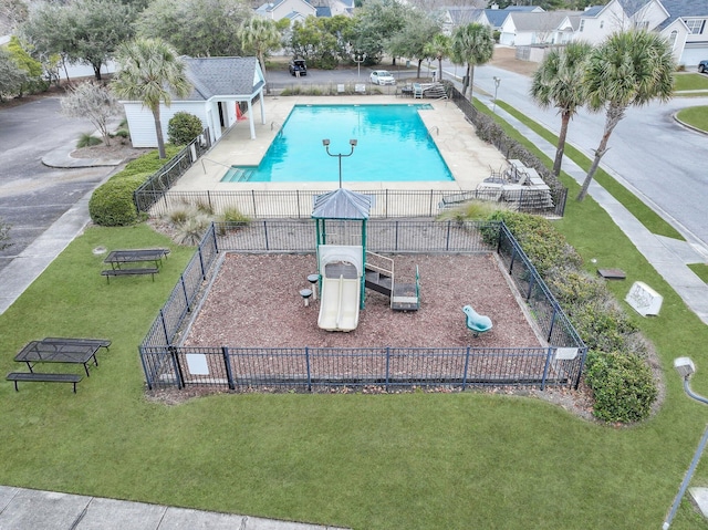 view of swimming pool with a playground, a patio area, and a lawn