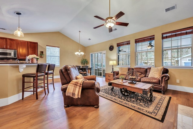 living room with a healthy amount of sunlight and light hardwood / wood-style floors