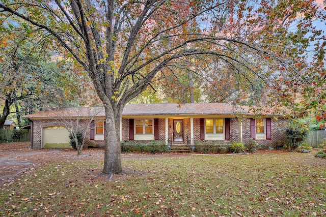 single story home with fence, driveway, brick siding, and a garage
