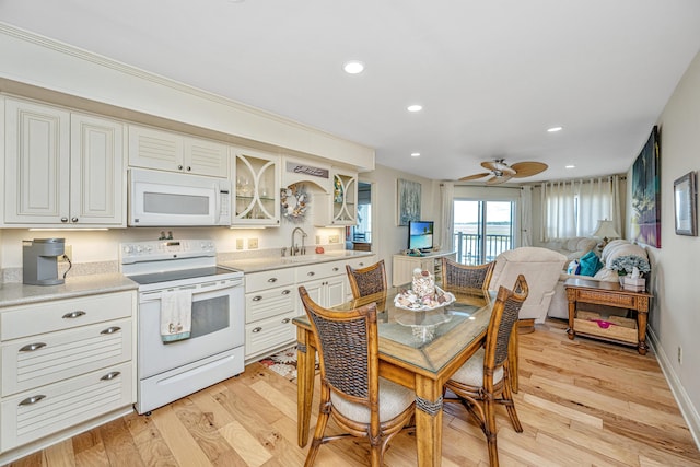 3701 Docksite Rd Unit 220, Edisto Island, SC 29438 - kitchen with white appliances, light wood-style flooring, light countertops, glass insert cabinets, and a sink