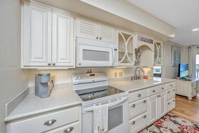 3701 Docksite Rd Unit 220, Edisto Island, SC 29438 - kitchen featuring white appliances, a sink, light wood-style flooring, light countertops, and white cabinetry
