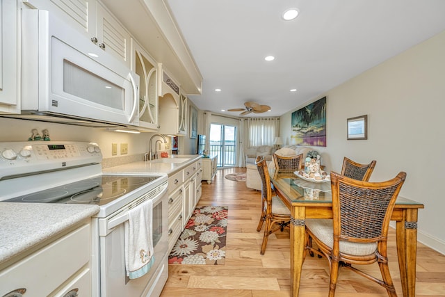 3701 Docksite Rd Unit 220, Edisto Island, SC 29438 - kitchen featuring white appliances, a sink, light wood-style flooring, light countertops, and recessed lighting