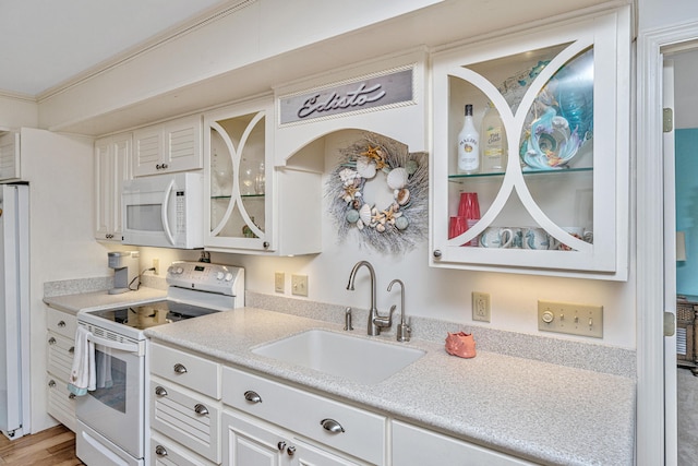 3701 Docksite Rd Unit 220, Edisto Island, SC 29438 - kitchen featuring white appliances, a sink, white cabinetry, light countertops, and glass insert cabinets