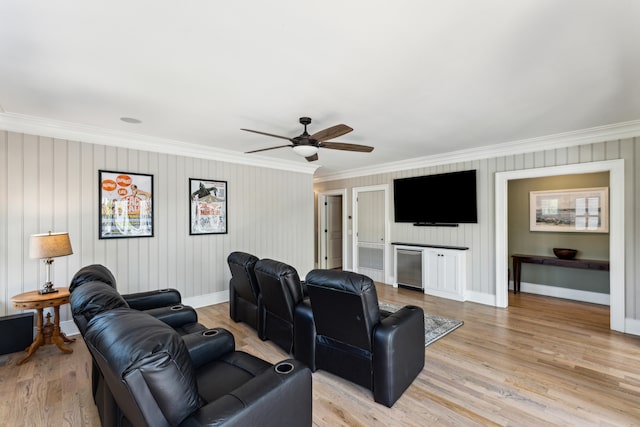 interior space featuring ceiling fan, crown molding, and light wood-type flooring