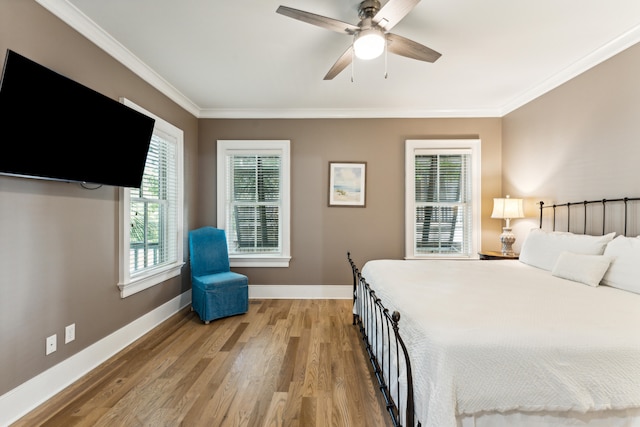 bedroom with ceiling fan, crown molding, and light wood-type flooring