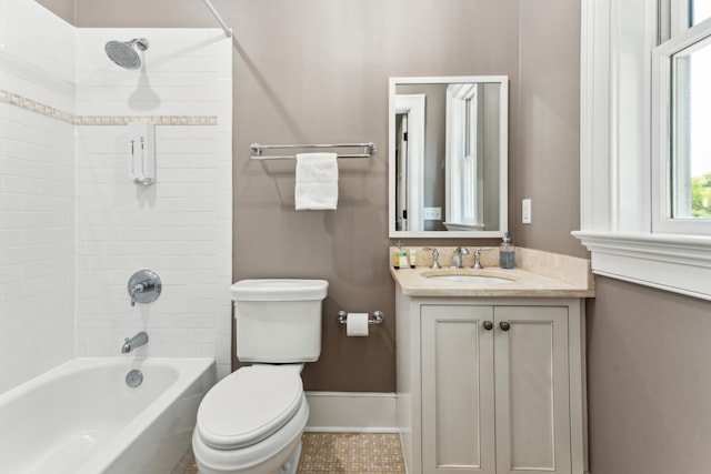 full bathroom featuring tile flooring, tiled shower / bath, vanity, and toilet