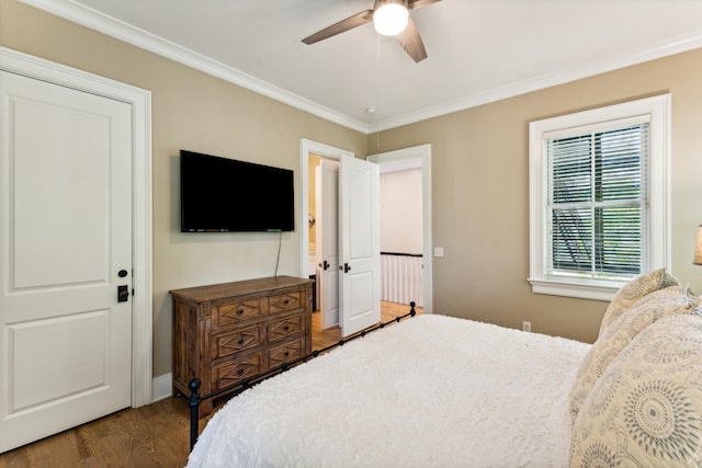 bedroom with ornamental molding, dark hardwood / wood-style flooring, and ceiling fan