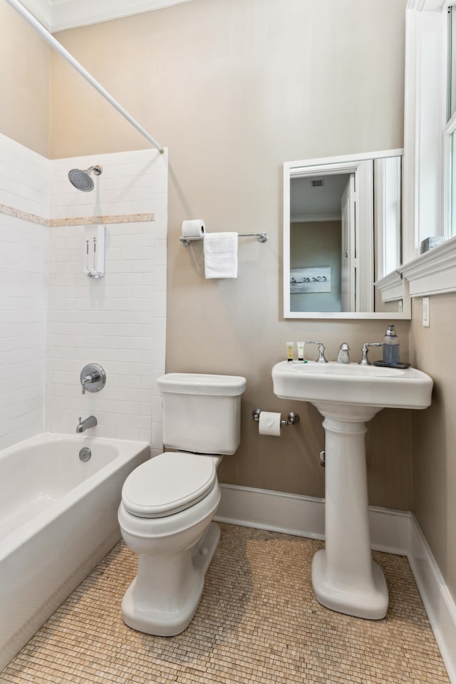 bathroom with tile floors, toilet, and tiled shower / bath