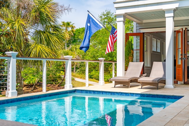 view of swimming pool featuring a patio area