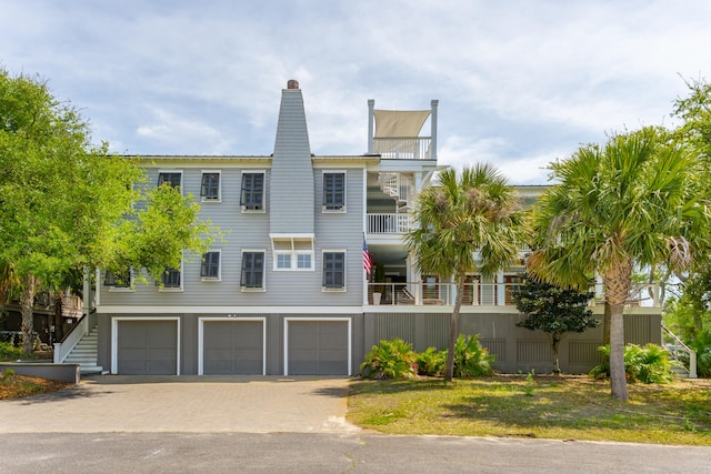 view of front facade with a garage and a balcony