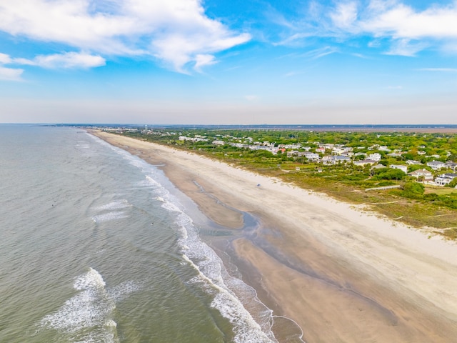 drone / aerial view featuring a water view and a view of the beach