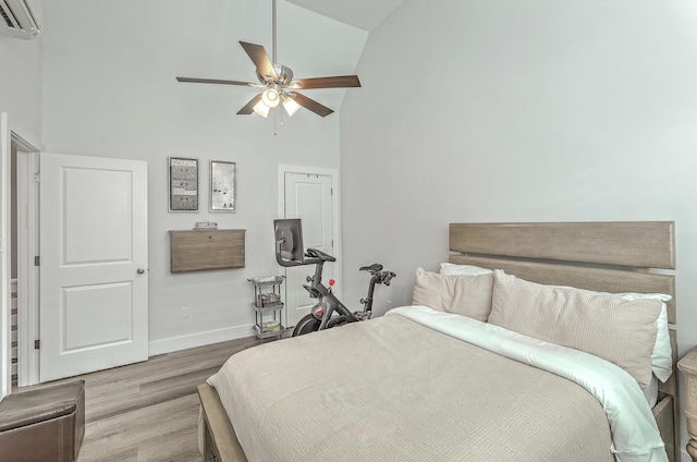 169 Jackson St, Charleston, SC 29403 - bedroom with ceiling fan, high vaulted ceiling, baseboards, a wall unit AC, and wood finished floors