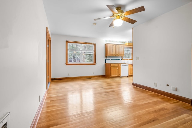 unfurnished living room with visible vents, ceiling fan, light wood-type flooring, and baseboards