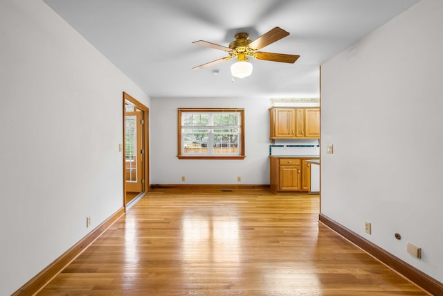 unfurnished living room with baseboards, light wood-style floors, and a ceiling fan