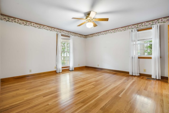 unfurnished room featuring visible vents, ceiling fan, baseboards, and light wood-style floors