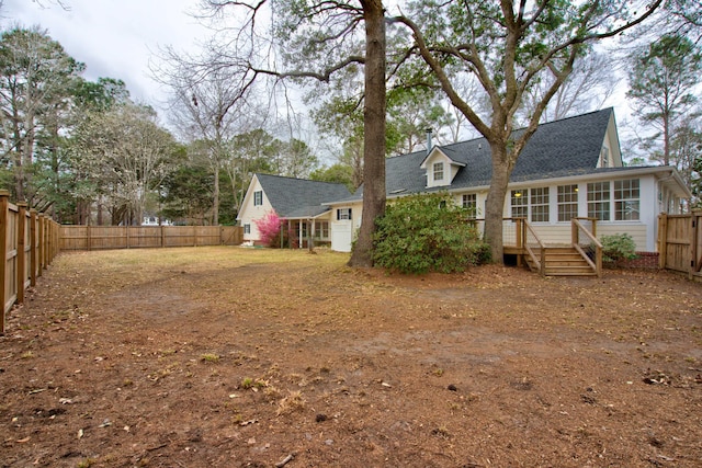 back of house featuring a fenced backyard