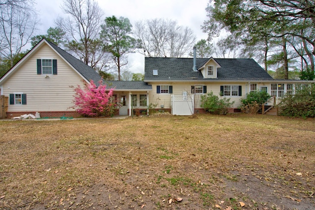 rear view of property featuring crawl space and a yard