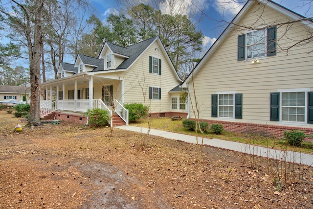 view of side of property with crawl space and covered porch