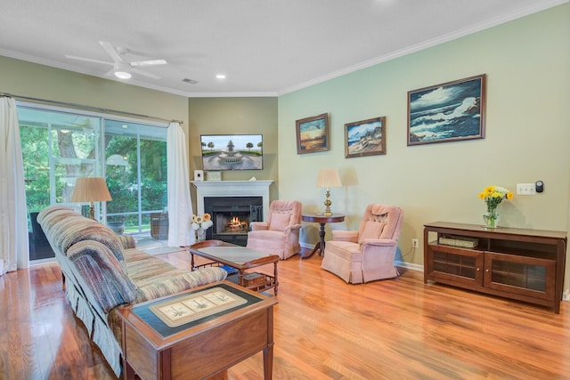 5406 E Crosland Ct, North Charleston, SC 29420 - living room with a warm lit fireplace, wood finished floors, ornamental molding, recessed lighting, and a ceiling fan