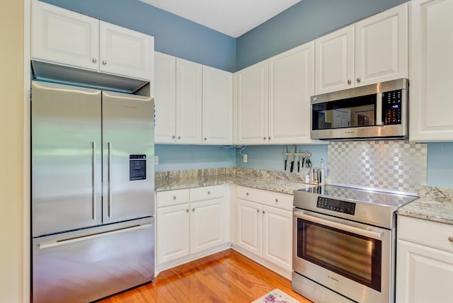 5406 E Crosland Ct, North Charleston, SC 29420 - kitchen with stainless steel appliances, white cabinets, light wood-style floors, and light stone countertops