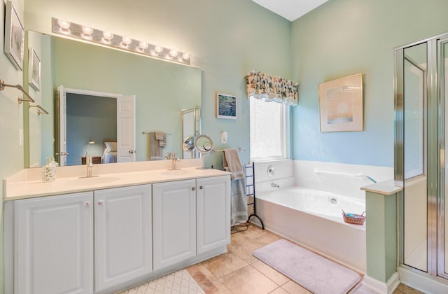 5406 E Crosland Ct, North Charleston, SC 29420 - ensuite bathroom featuring a garden tub, a shower stall, double vanity, and tile patterned floors