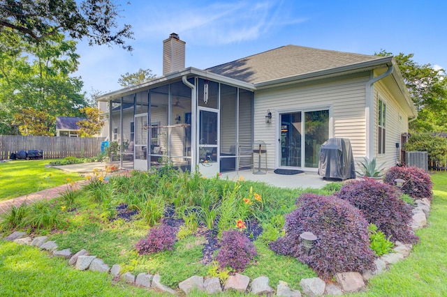 5406 E Crosland Ct, North Charleston, SC 29420 - rear view of property with a sunroom, a chimney, a patio, and a ceiling fan