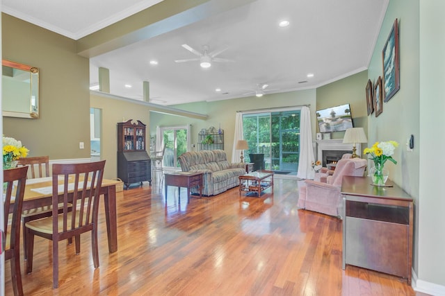 5406 E Crosland Ct, North Charleston, SC 29420 - living room with a lit fireplace, crown molding, wood finished floors, a ceiling fan, and recessed lighting