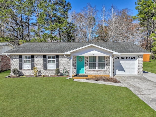 ranch-style house featuring a garage and a front lawn