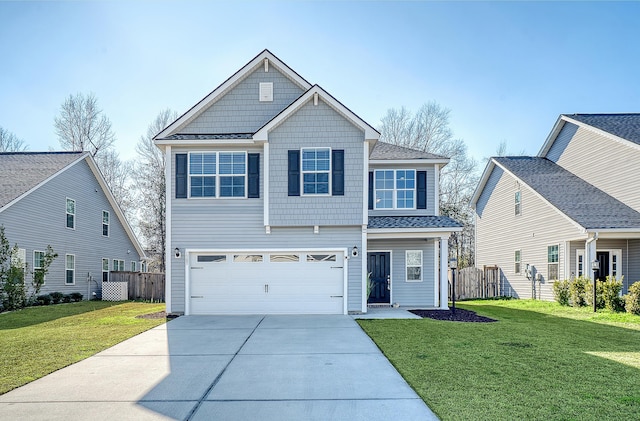 view of front of home featuring a garage, driveway, a front yard, and fence