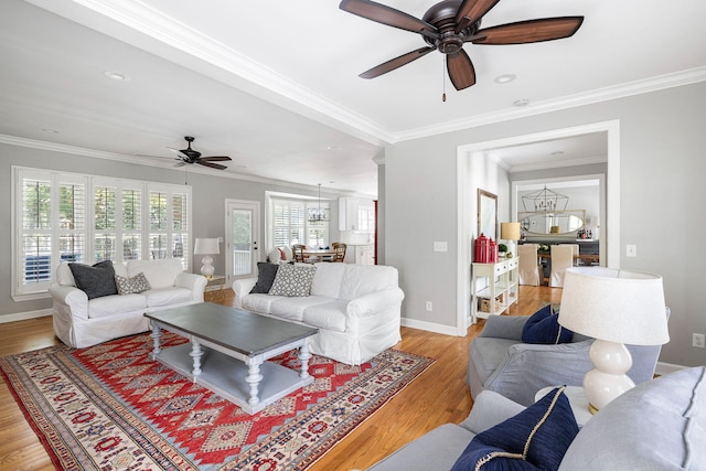 living area with a ceiling fan, crown molding, light wood-type flooring, baseboards, and recessed lighting