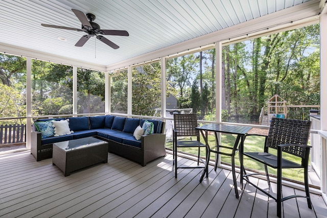 sunroom with a ceiling fan and outdoor lounge area