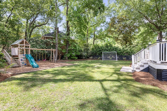 view of yard featuring fence and a playground