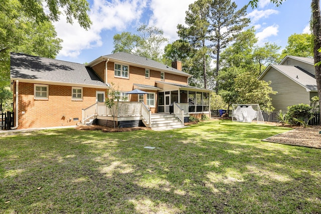 rear view of house featuring fence, a chimney, a sunroom, and brick siding