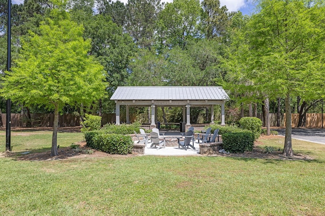 view of yard featuring a gazebo, fence, and a fire pit