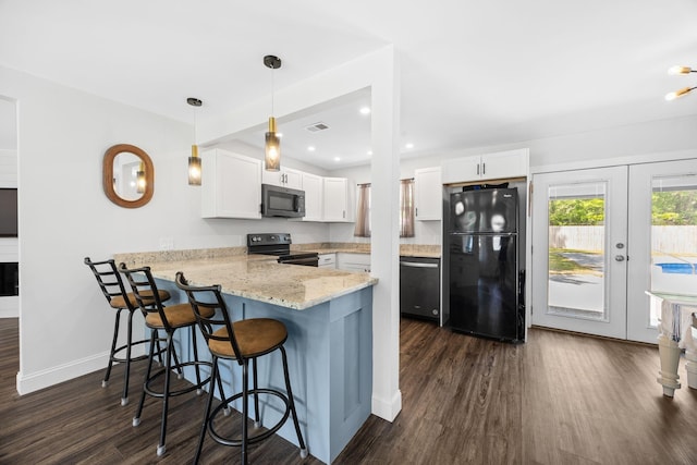 8767 Auburn Dr, North Charleston, SC 29406 - kitchen featuring black appliances, a peninsula, dark wood-style flooring, white cabinets, and recessed lighting