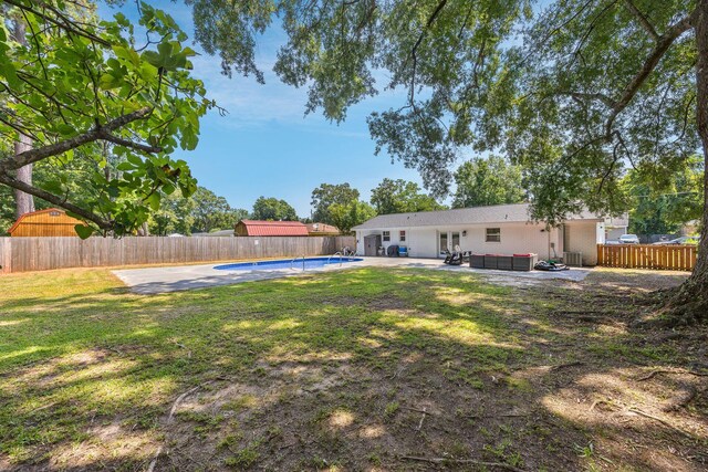 8767 Auburn Dr, North Charleston, SC 29406 - fenced backyard with a jacuzzi and a patio area