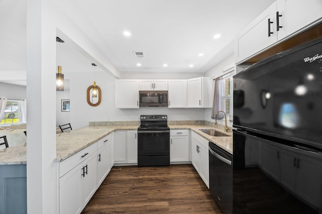 8767 Auburn Dr, North Charleston, SC 29406 - kitchen featuring black appliances, light stone counters, dark wood-type flooring, white cabinetry, and a peninsula