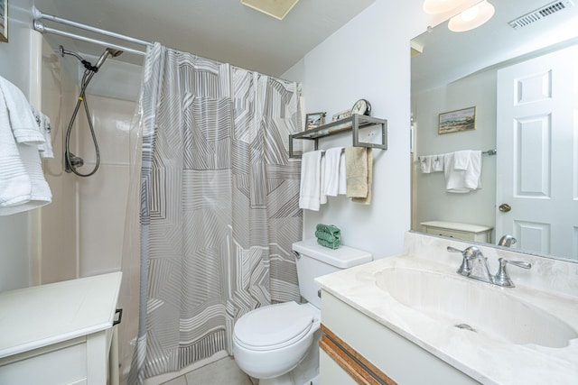 bathroom featuring tile patterned flooring, a shower with curtain, vanity, and toilet