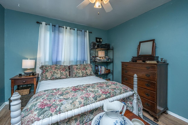 bedroom with hardwood / wood-style flooring and ceiling fan