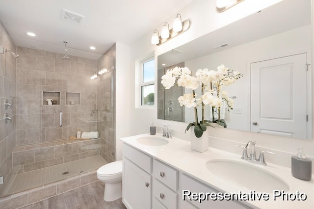 1219 Homecoming Blvd Unit Cc1-27, Ravenel, SC 29470 - bathroom with double vanity, a shower stall, wood finished floors, and recessed lighting
