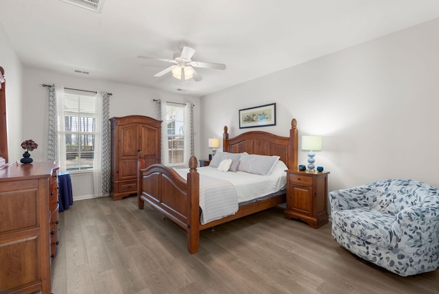 bedroom featuring baseboards, light wood-style flooring, and a ceiling fan