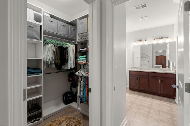 walk in closet featuring light floors and visible vents