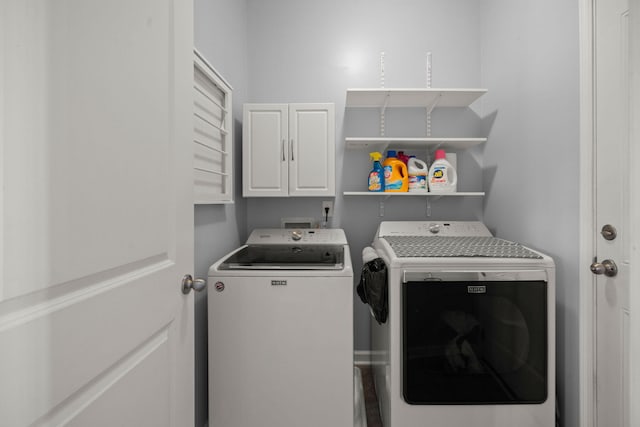 laundry area featuring cabinet space and washer and clothes dryer